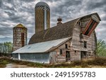 Old barn. Clouds over the old barn. Old barn on farmland. Farmland old barn