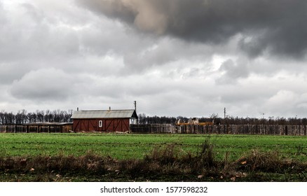 old barn in the field with clouds