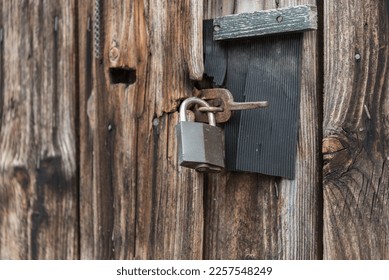 Old barn gate with a padlock locked - closeup - Shutterstock ID 2257548249