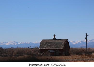 Old barn with mountains in the background