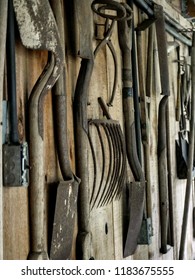 Old Barn Tools Hanging On Barn Wall.