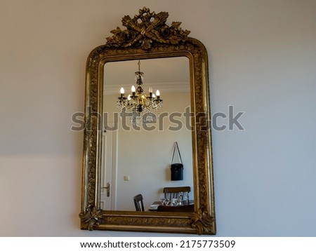 Old Baroque Gothic style antique Mirror hanging on the wall Detail shot home decoration object abstract pastel background image luxury buying now. 