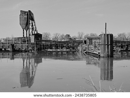 An old bascule railroad bridge,also known as a drawbridge or a lifting bridge, with a counterweight.Over Overpeck Creek in N.J.entrance to the Hackensack River. In Black and White.