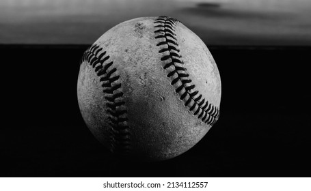 Old Baseball Ball Close Up In Black And White For Nostalgic Sports Background In Shallow Depth Of Field.