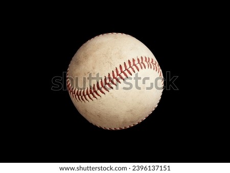 Old baseball ball isolated, black background
