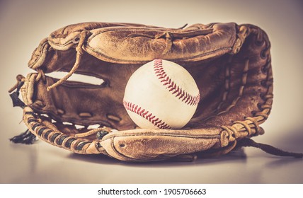 old baseball glove with ball and bat