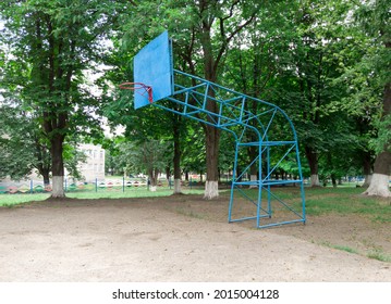 Old Basketball Board In A School Court Yard. Basketball Hoop For Amateur Sports. Old Sport Equipment.