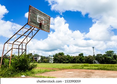 Old basketball hoop and wooden board on blue sky background