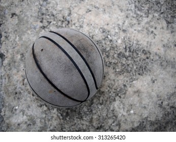 Old Basketball On The Cement Floor