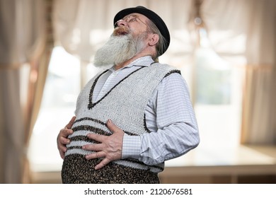 Old Bearded Man Is Lauging And Touching His Belly.