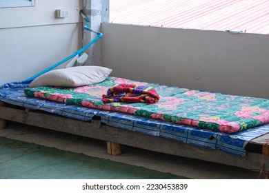Old Bed of a Homeless Man in an Abandoned Building in the City - Shutterstock ID 2230453839