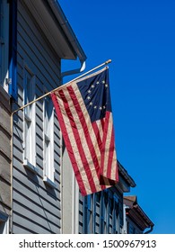 An Old Betsy Ross Flag Hanging On A House