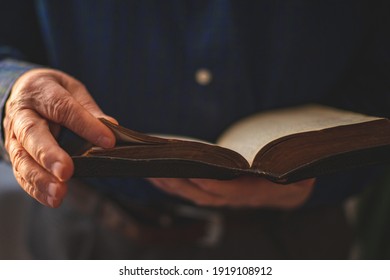 Old Bible in hands of an old man
