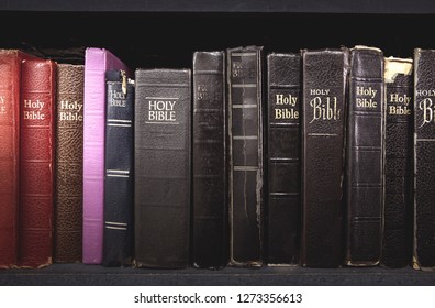 Old Bible on wooden shelf. Tiled Bookshelf background.