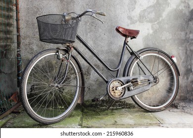 old bicycle over a shabby background