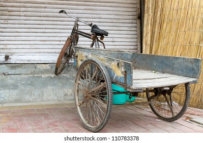 Old Bicycle With Trailer In Delhi, India, In Front Of A Closed Shop