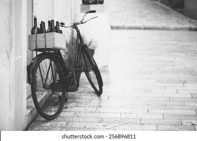 Old Bicycle With Wooden Box Full Of Wine Bottles