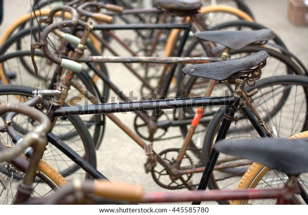 Old bicycles parked\
in an antique market