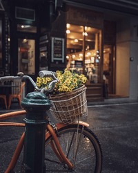 An Old Bike With A Basket Full Of Flowers