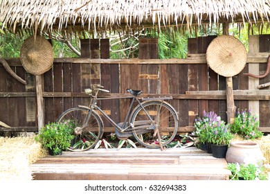 Old Bike  On Wood Stage And  Vintage Basketry Background