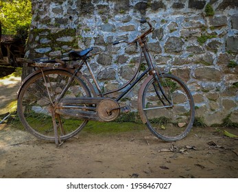 The Old Bike Photo With Stone Fence Background.