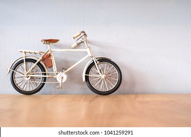 Old Bike Toy On Wooden Table 
 