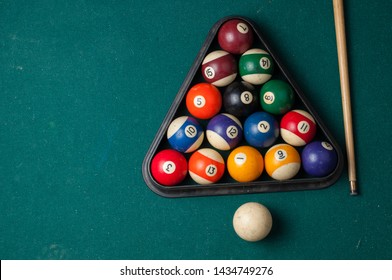 Old billiard ball and stick  on a green table. billiard balls isolated on a green background.