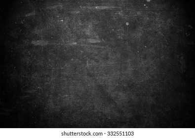 Old black background. Grunge texture. Dark wallpaper. Blackboard. Chalkboard. Concrete wall