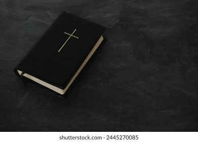 old black book, family bible in dark cover, golden cross, goose feather, concept of intermediary between God and world, eternal Christian values, unity of people in faith - Powered by Shutterstock