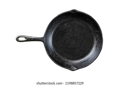 Old black cast iron pan isolated over a white background with clipping path included. Image of skillet shot from overhead.