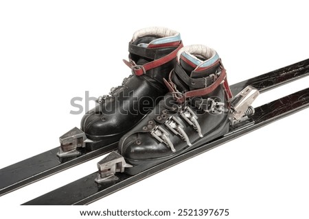 Old black leather ski boots isolated on white.