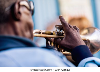 An Old Black Man In Blue Jacket Playing Trumpet. Vinales In Cuba.