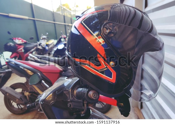 Old black\
motorcycle helmet in the car\
park.