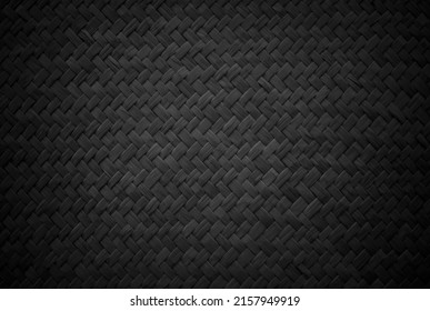 Old black reed weaving mat texture background, pattern of woven rattan mat in vintage style.