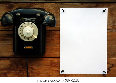 Old Black Rotary Phone And White Paper.