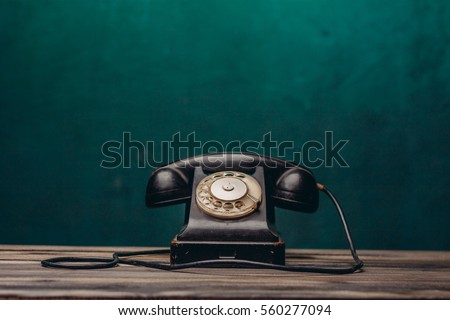 old black telephone on dark background