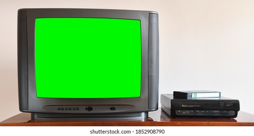 Old Black Vintage Green Screen TV From 1980s 1990s 2000s For Adding New Images To The Screen, VCR In The Background Of Wallpaper.