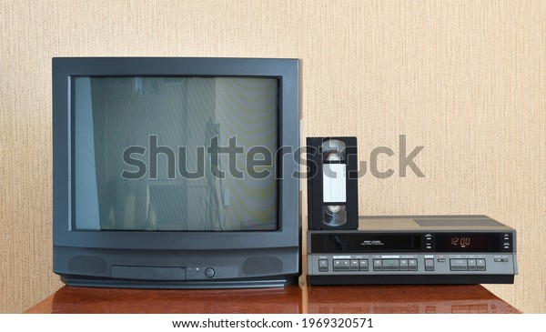 Old black\
vintage TV from 1980s 1990s 2000s for adding new images to the\
screen, VCR in the background of\
wallpaper.