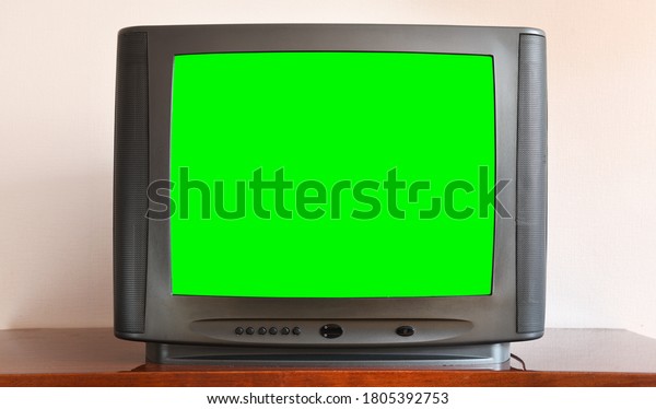 Old black vintage TV with green screen to add new\
images to the screen.