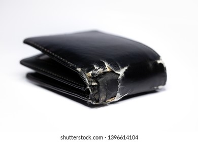 Old Black Wallet On White Background. Worn Out Leather Wallet. Selective Focus