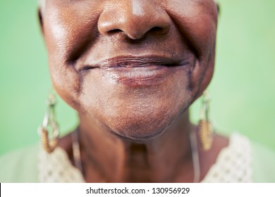 Old Black Woman Portrait, Close-up Of Eye And Face On Green Background. Copy Space