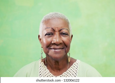 Old Black Woman Portrait, Lady In Elegant Clothes Smiling On Green Background. Copy Space