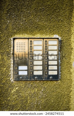 Old blank intercom device mockup on worn facade