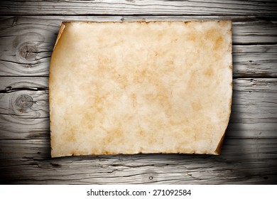 old blank parchment on aged grey wooden wall - Shutterstock ID 271092584