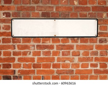 Old Blank White British Street Sign On A Red Brick Wall.