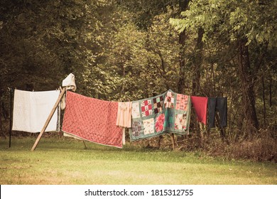 Old Blankets And Quilts Hanging Out On The Clothes Line