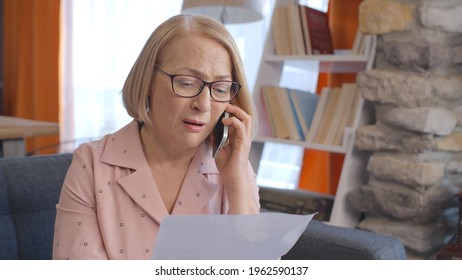 The Old Blonde Woman Is Getting Angry On The Phone For High Invoice And Asking For An Account. High Invoice Concept.