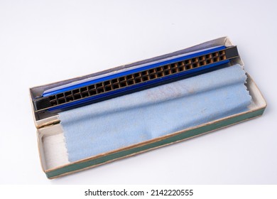 old blue harmonica that is starting to fade, a bit dull