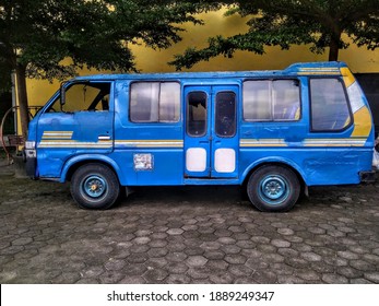 Old Blue Minibus Is Used For Transportation