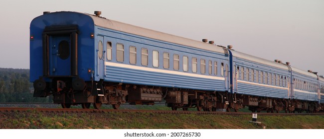 Old Blue Passenger Train Last Wagon At Sunny Summer Evening